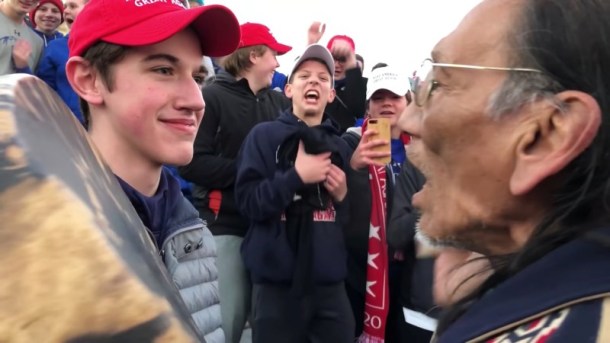 A student from Covington Catholic High School stands in front of Native American Vietnam veteran Nathan Phillips in Washington